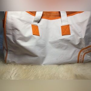 White and orange clearance beach tote. Lined washable outside pockets.